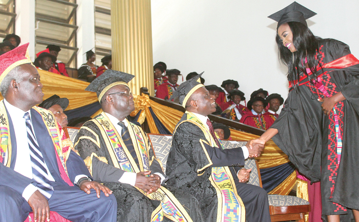 Rev. Prof. Cephas Omenyo (2nd right), acting Pro Vice-Chancellor, Research, Innovation and Development, University of Ghana, Legon, congratulating Ms Carranzer Laverne Shooter (right), one of the graduates at the ceremony. Looking on are Prof. Ebenezer Oduro Owusu (2nd left) and Prof. Kwamena Ahwoi (left), Chairman of University of Ghana Council. Picture: EDNA ADU-SERWAA